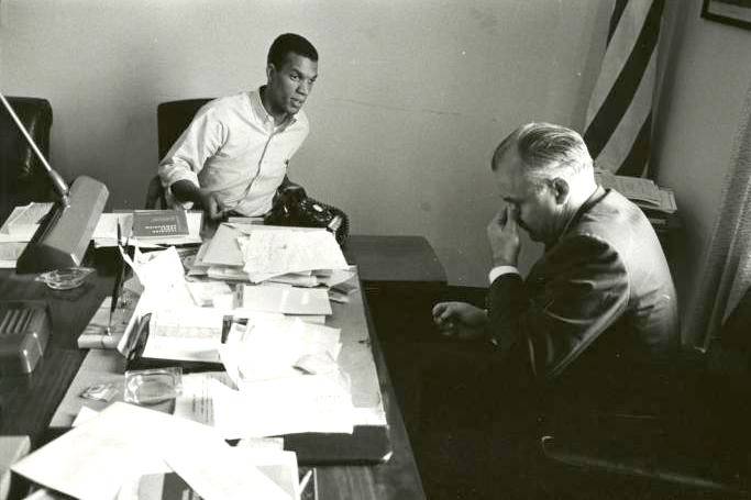 Ivanhoe Donaldson, civil rights activist, speaking with Georgia State congressman in his office.